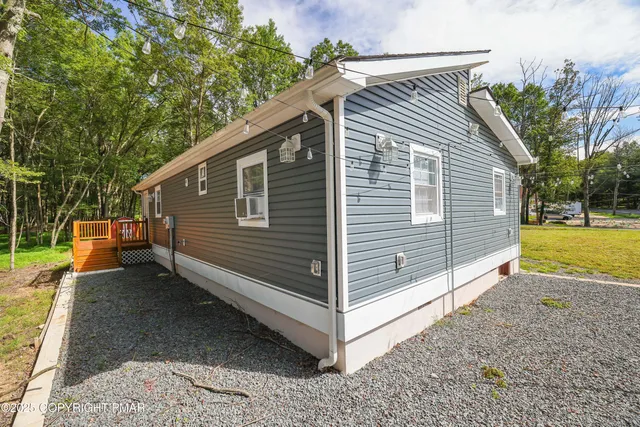 a backyard of a house with table and chairs