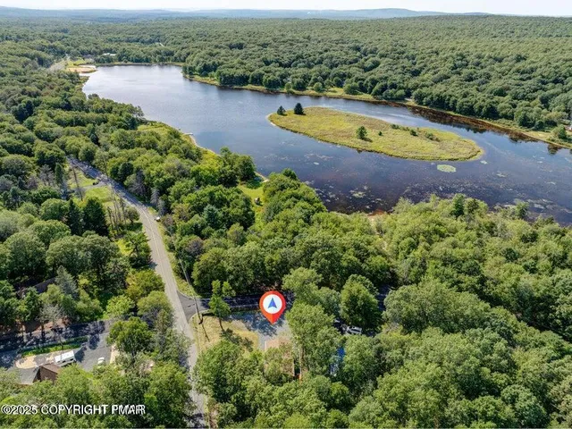 an aerial view of residential house with outdoor space and swimming pool