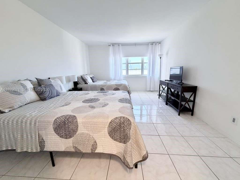 100 Lincoln Road, Unit 541 Miami Beach, FL 33139 - Photo 11 of 17 a living room with furniture and a mirror