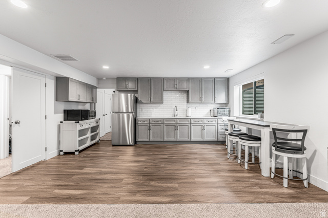 313 Old Maple Road South Weber, UT 84405 - Photo 19 of 35 Kitchenette featuring gray shaker-style cabinetry, a subway tile backsplash, and stainless steel appliances