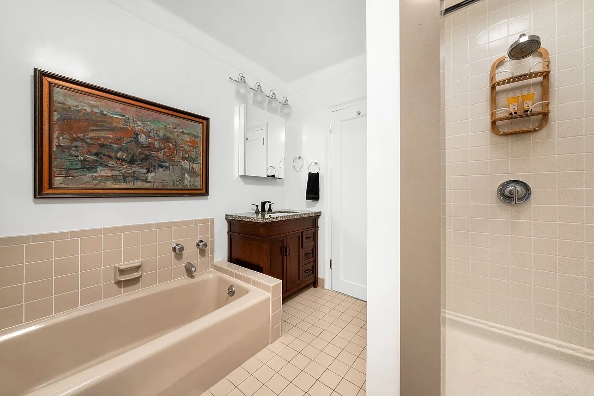 277 West End Avenue, Unit 12MA Manhattan, NY 10023 - Photo 10 of 12 a bathroom with a tub and a shower