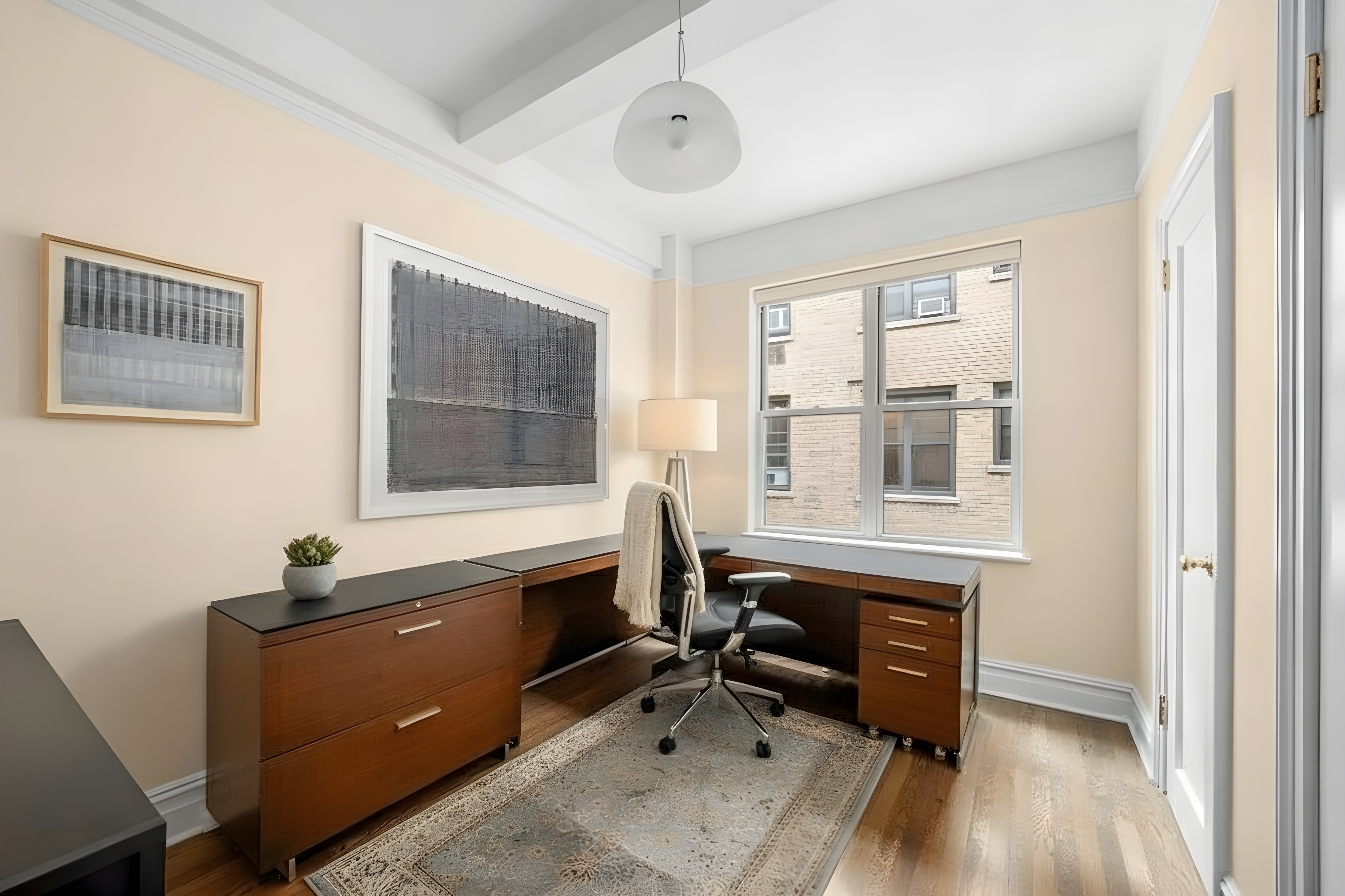 277 West End Avenue, Unit 12MA Manhattan, NY 10023 - Photo 11 of 12 a view of a workspace with furniture and a window