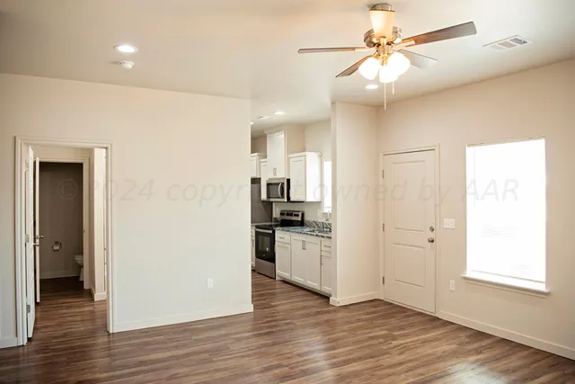 a view of an empty room and wooden floor