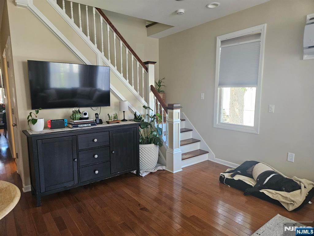 15 William Street, Unit 2 Rochelle Park, NJ 07662 - Photo 2 of 12 a room with stairs and a flat screen tv