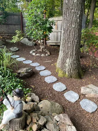 a view of a backyard with chair and fire pit