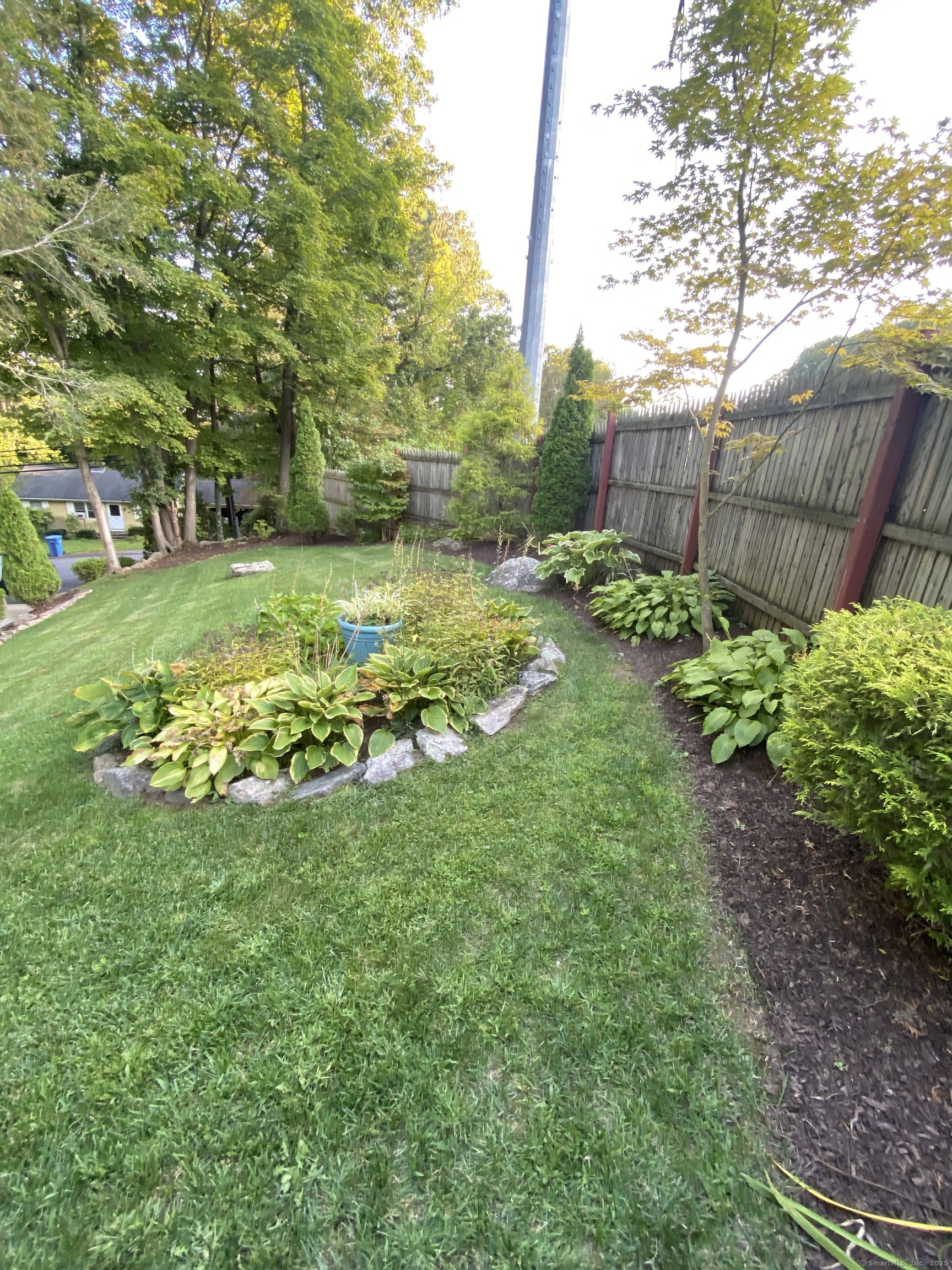 110 Wooster Avenue Waterbury, CT 06708 - Photo 13 of 35 a view of a garden with a bench
