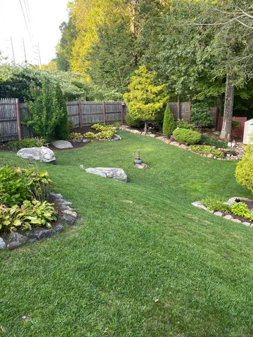 a view of a garden with a house