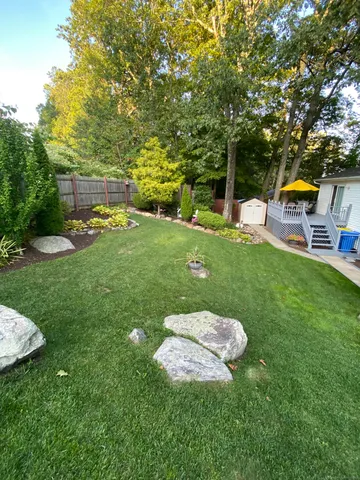 a backyard of a house with table and chairs