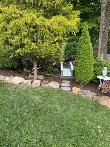 a backyard of a house with lots of green space