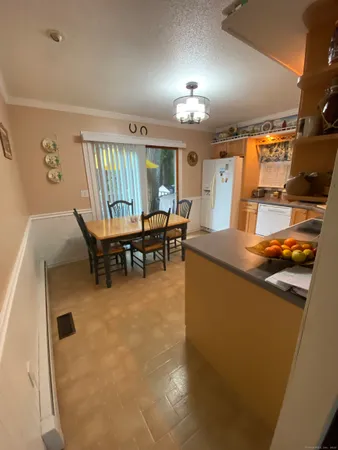 a dining room with furniture and chandelier