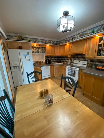 a very nice looking dining room with a large bed and a chandelier