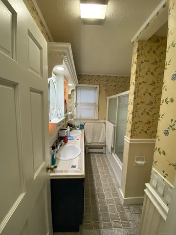 a bathroom with a sink toilet and shower