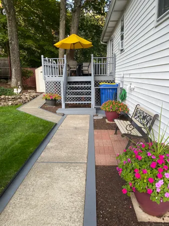 a view of a chairs and table in the back yard of the house