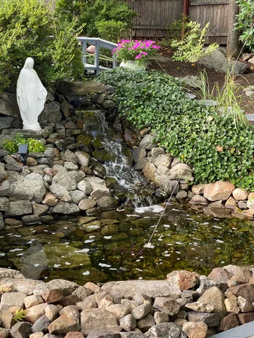 a front view of a house with a yard and garden