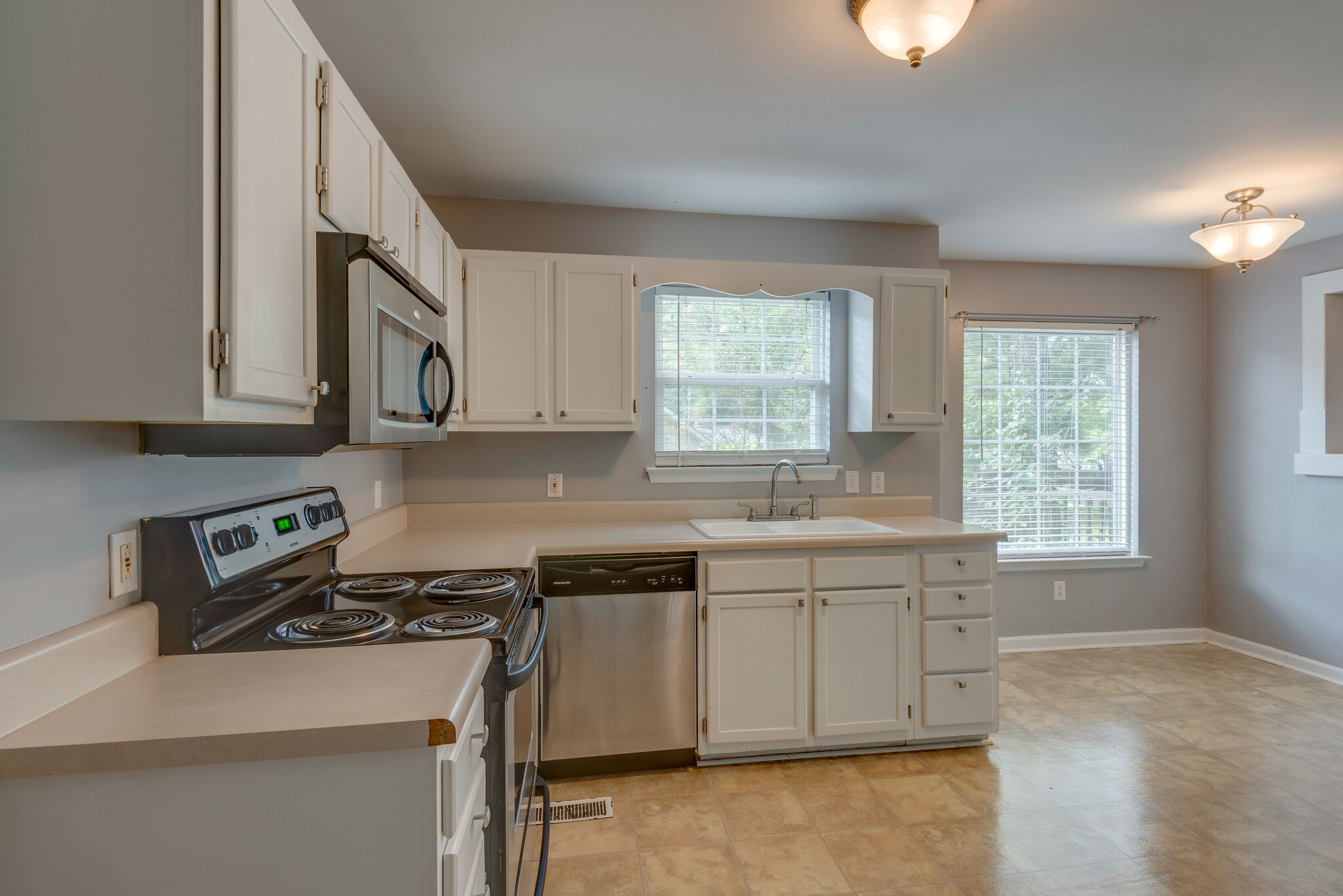7325 Matthew Street Fairview, TN 37062 - Photo 4 of 27 a kitchen with stainless steel appliances granite countertop a stove a sink and a microwave
