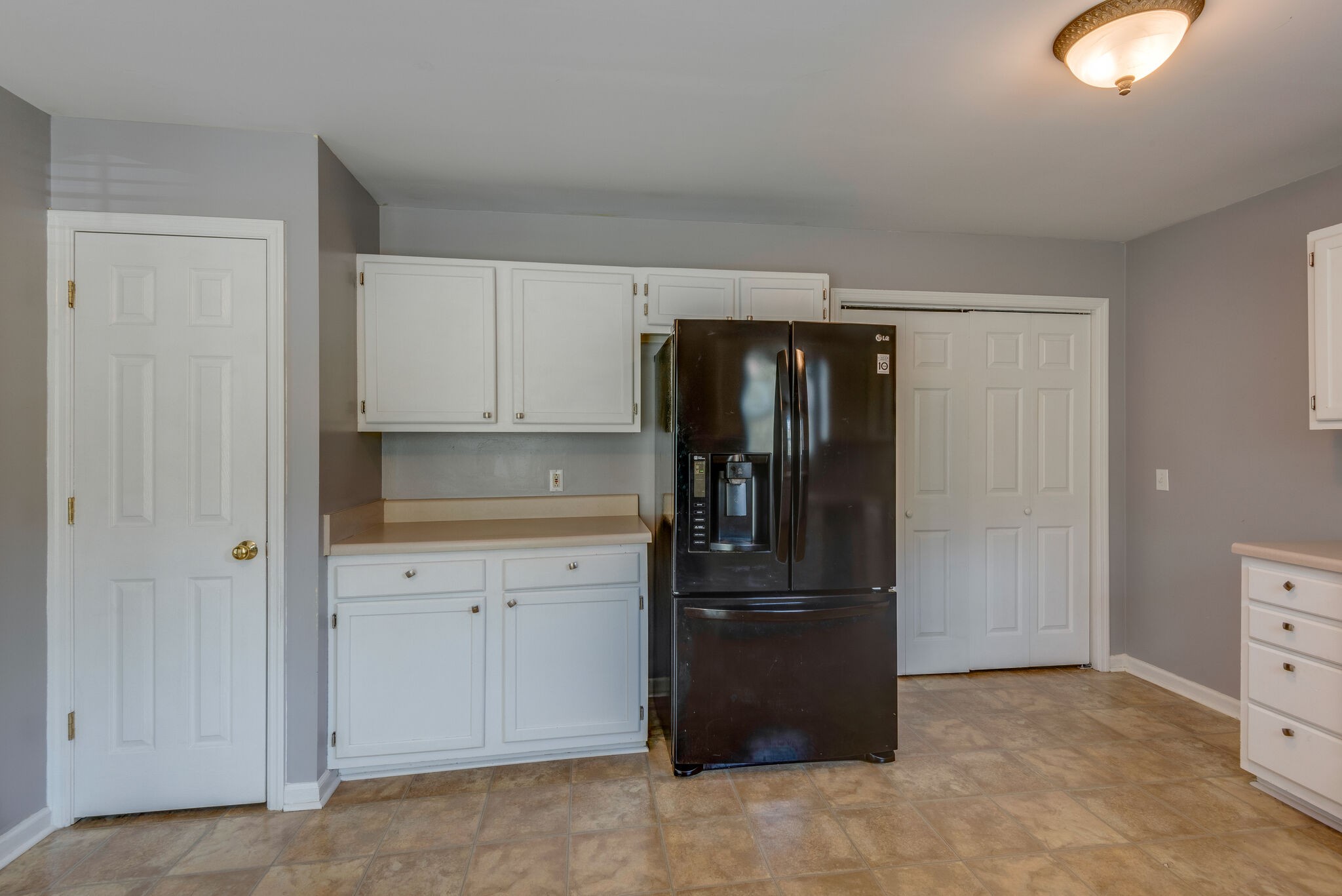 7325 Matthew Street Fairview, TN 37062 - Photo 8 of 27 a kitchen with a refrigerator and cabinets