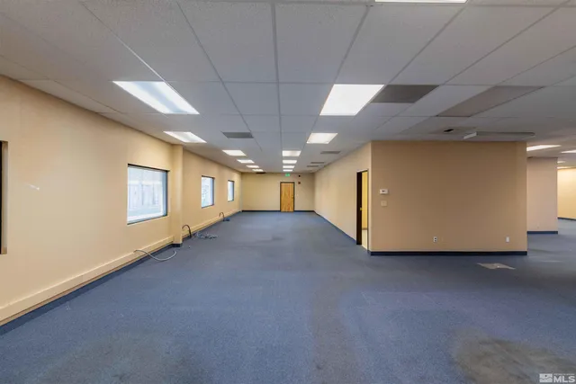 a view of an empty room and bathroom