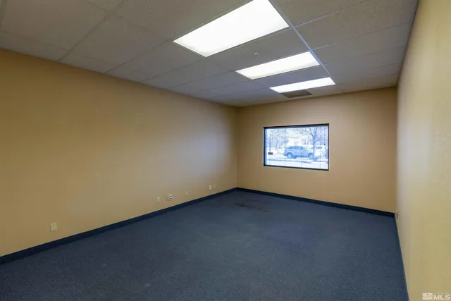 an empty room with a empty space and a window