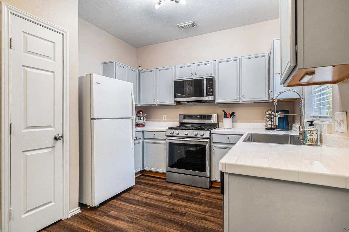 23644 Wildwood Green Way Spring, TX 77373 - Photo 10 of 25 The cabinets and pantry provide excellent storage for all your kitchen essentials!