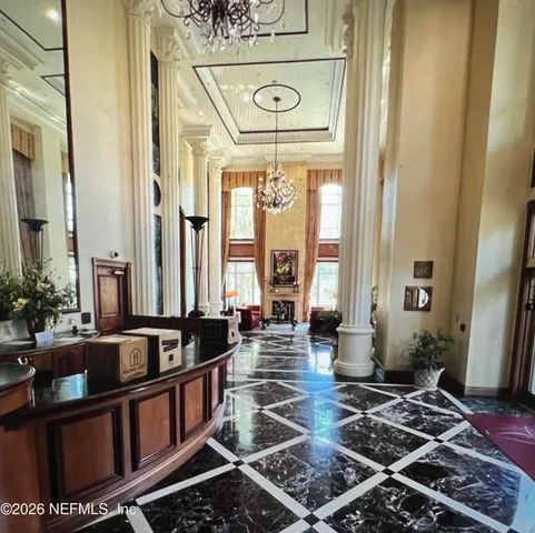 a lobby with furniture and floor to ceiling window