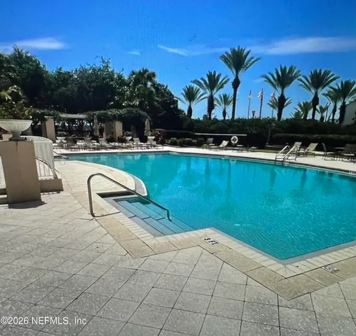 a living room with fireplace furniture and a potted plant