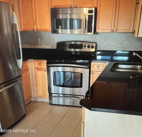 a kitchen with stainless steel appliances a stove and a refrigerator