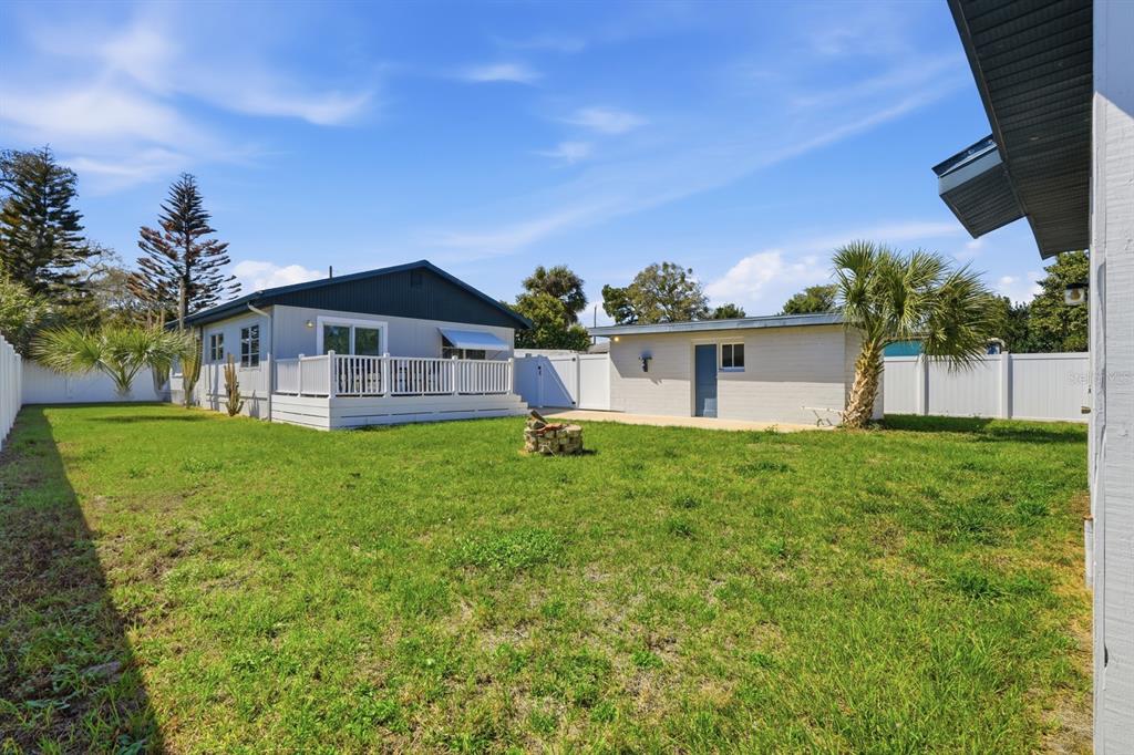 231 North Ridgewood Avenue Ormond Beach, FL 32174 - Photo 35 of 52 a front view of a house with a yard and garage