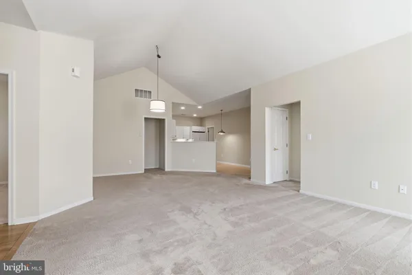 a view of a kitchen with a sink and a refrigerator