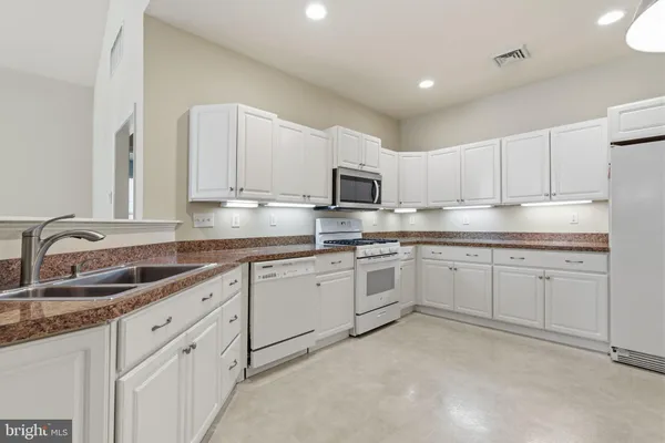 a kitchen with sink cabinets and microwave