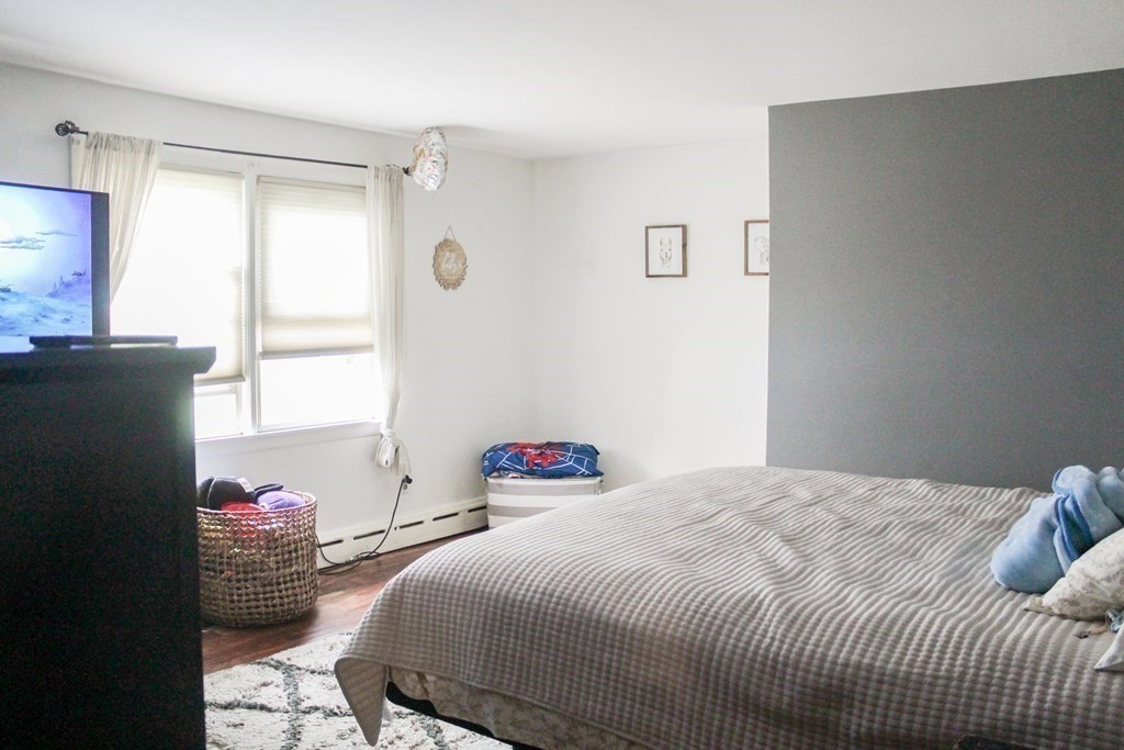 76 Embury Street Springfield, MA 01109 - Photo 7 of 18 a bedroom with a bed and a window