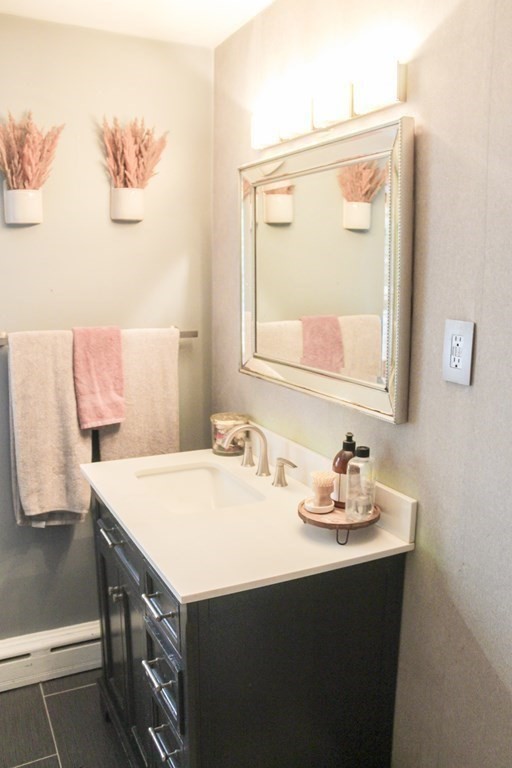 76 Embury Street Springfield, MA 01109 - Photo 10 of 18 a bathroom with a sink vanity and a mirror