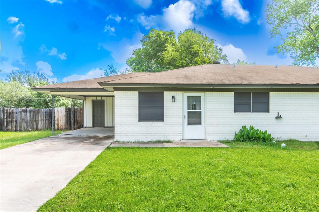 a view of a house with a yard and a garden