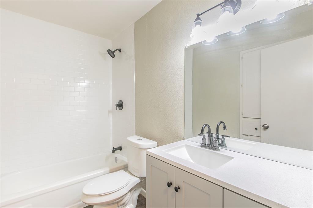 600-614 Riggins Street Robinson, TX 76706 - Photo 11 of 16 a bathroom with a sink a toilet and shower