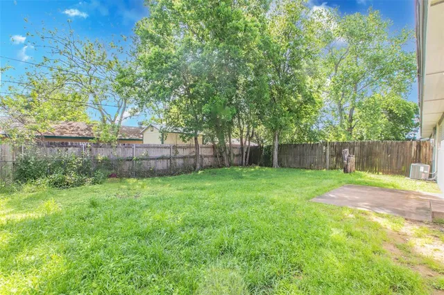 a view of house with backyard