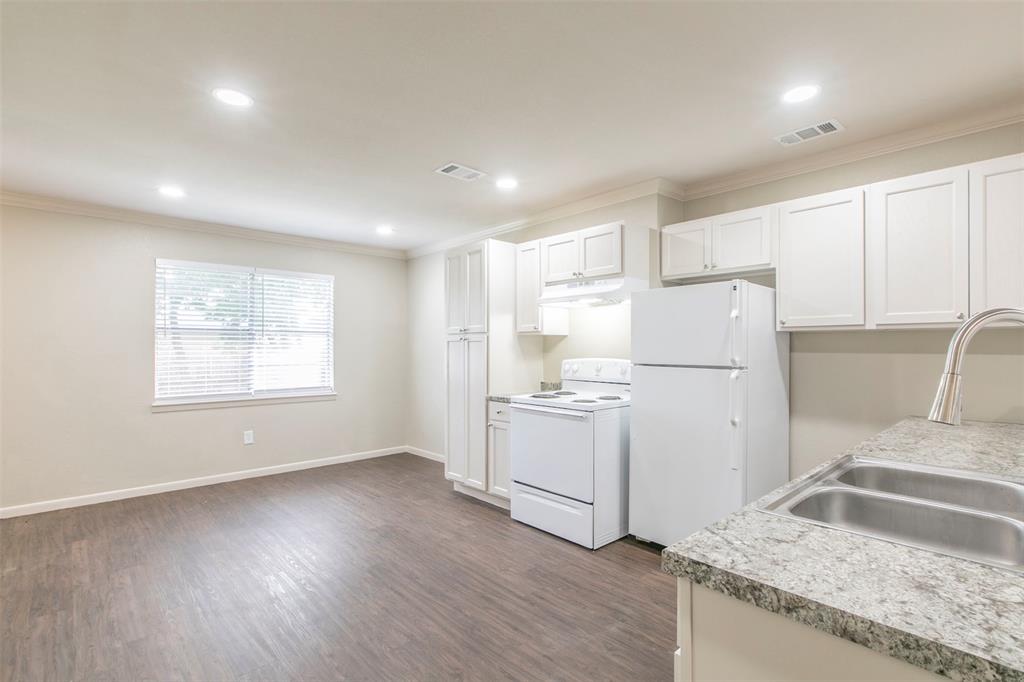 600-614 Riggins Street Robinson, TX 76706 - Photo 5 of 16 a kitchen with refrigerator and window
