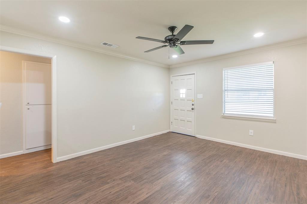 600-614 Riggins Street Robinson, TX 76706 - Photo 8 of 16 an empty room with wooden floor fan and windows