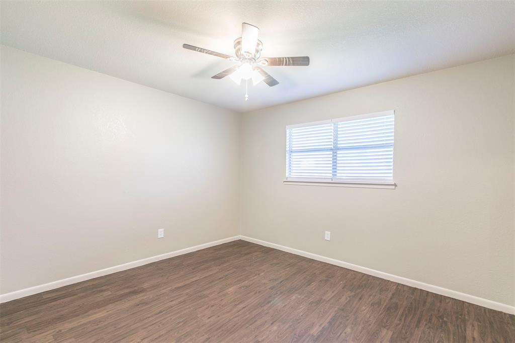 600-614 Riggins Street Robinson, TX 76706 - Photo 9 of 16 an empty room with wooden floor and windows