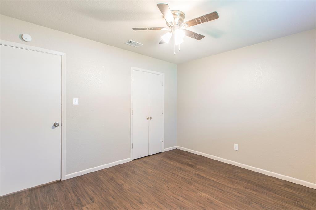 600-614 Riggins Street Robinson, TX 76706 - Photo 10 of 16 a view of an empty room with wooden floor