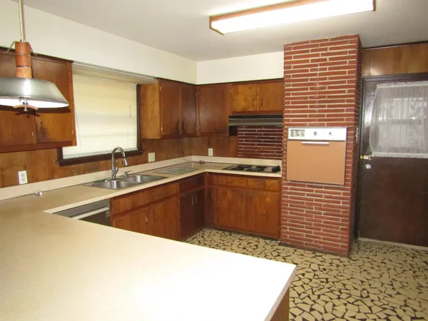 a kitchen with a sink and a stove top oven