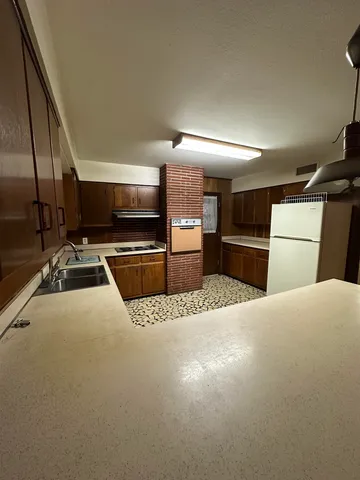 a kitchen with stainless steel appliances a stove a refrigerator and a sink