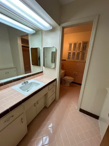a bathroom with a double vanity sink and mirror
