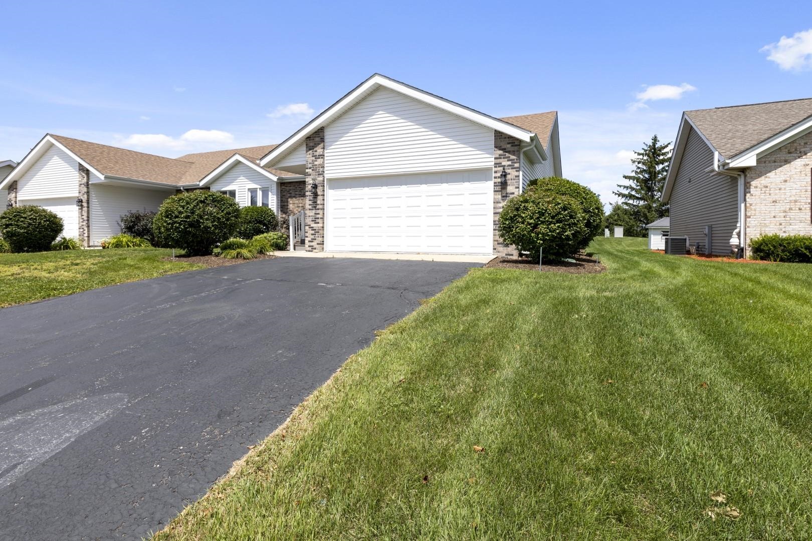 6682 North Point Road Rockford, IL 61108 - Photo 32 of 34 a front view of a house with a yard and garage