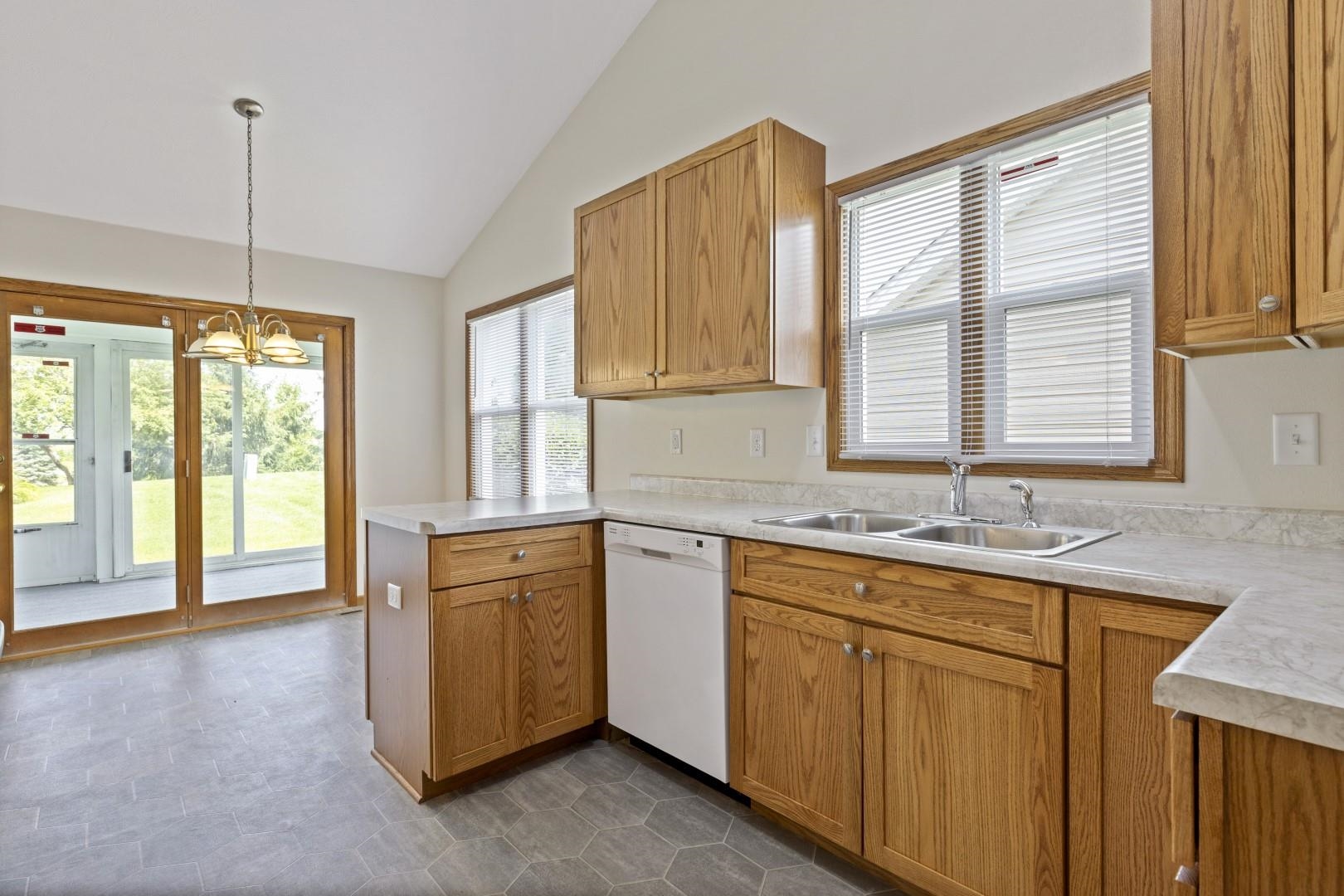 6682 North Point Road Rockford, IL 61108 - Photo 5 of 34 a kitchen that has a sink cabinets appliances and a window