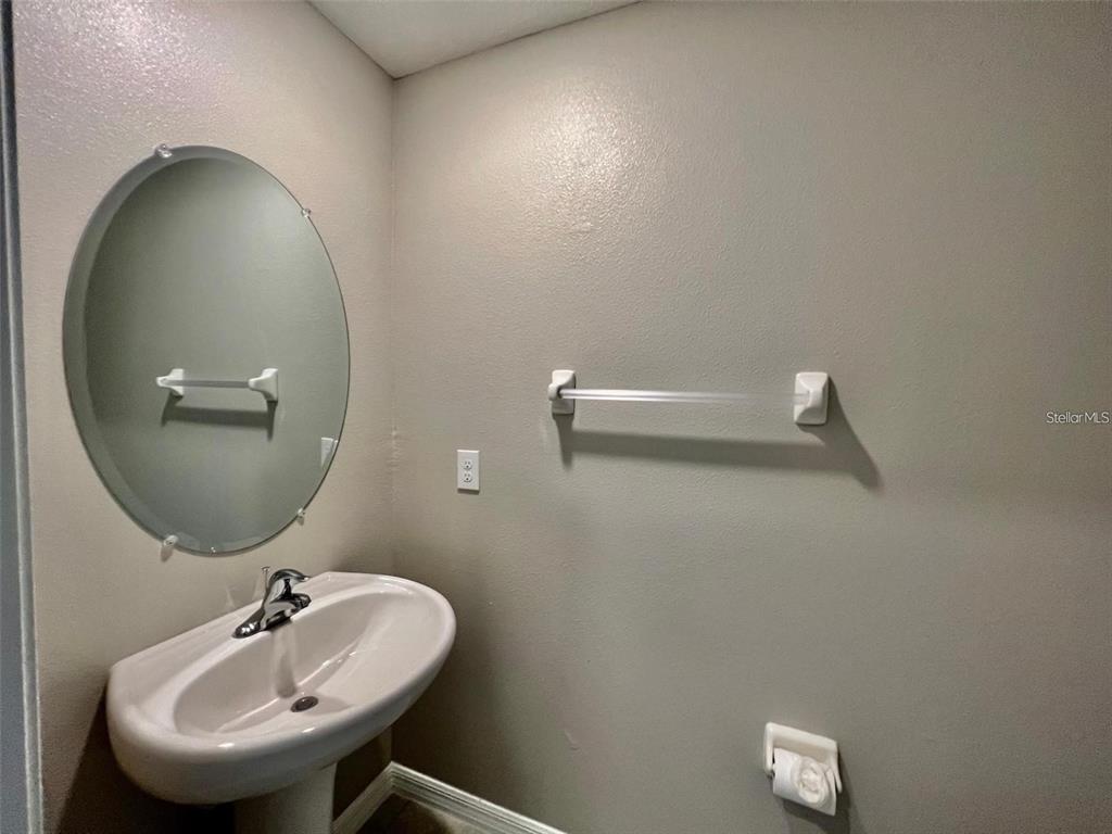31730 Barrel Wave Way Wesley Chapel, FL 33545 - Photo 7 of 14 a bathroom with a sink and mirror