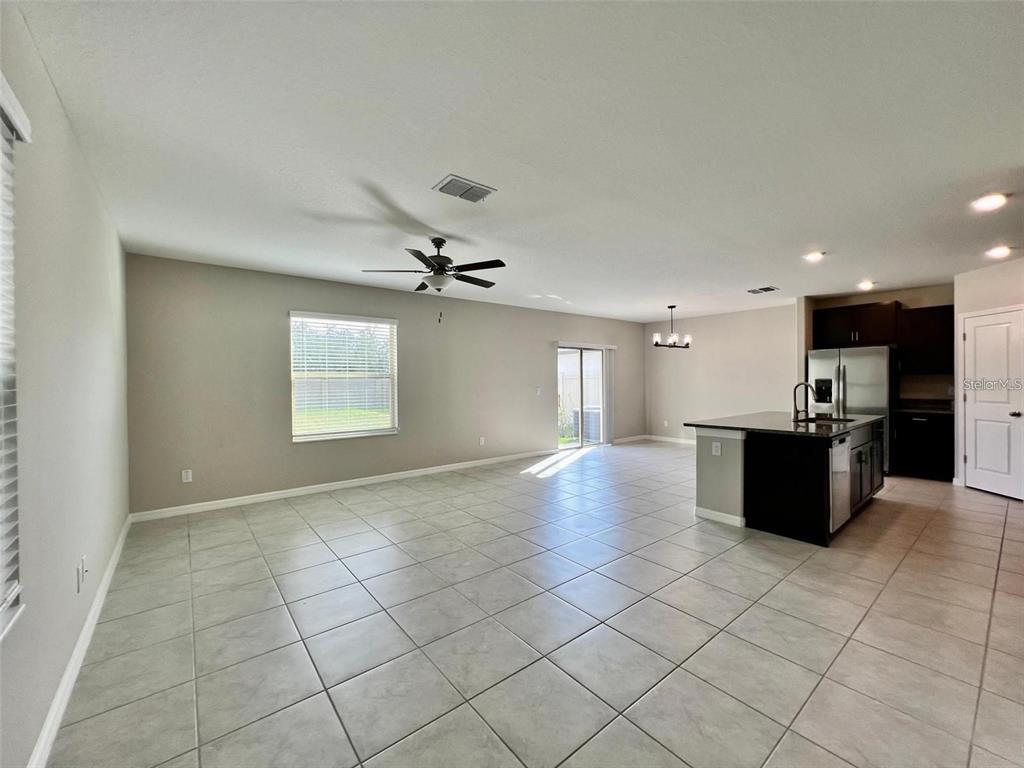 31730 Barrel Wave Way Wesley Chapel, FL 33545 - Photo 9 of 14 a view of a kitchen with kitchen island stainless steel appliances a counter space and a window