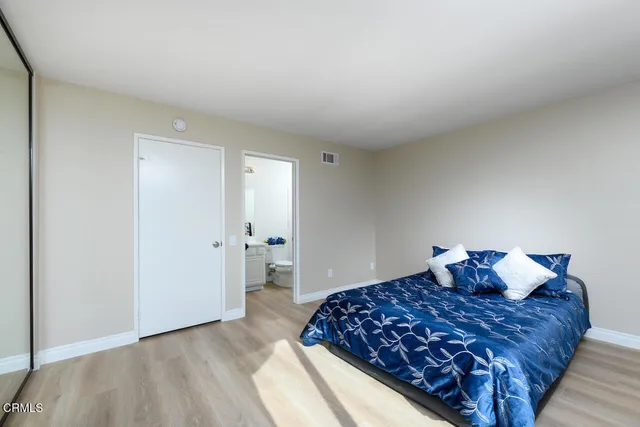 a bedroom with a bed and cabinets