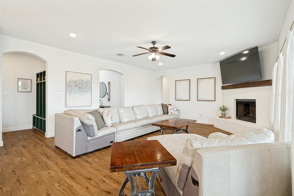 9424 Wildcat Ridge Godley, TX 76044 - Photo 4 of 25 a living room with fireplace furniture and a flat screen tv