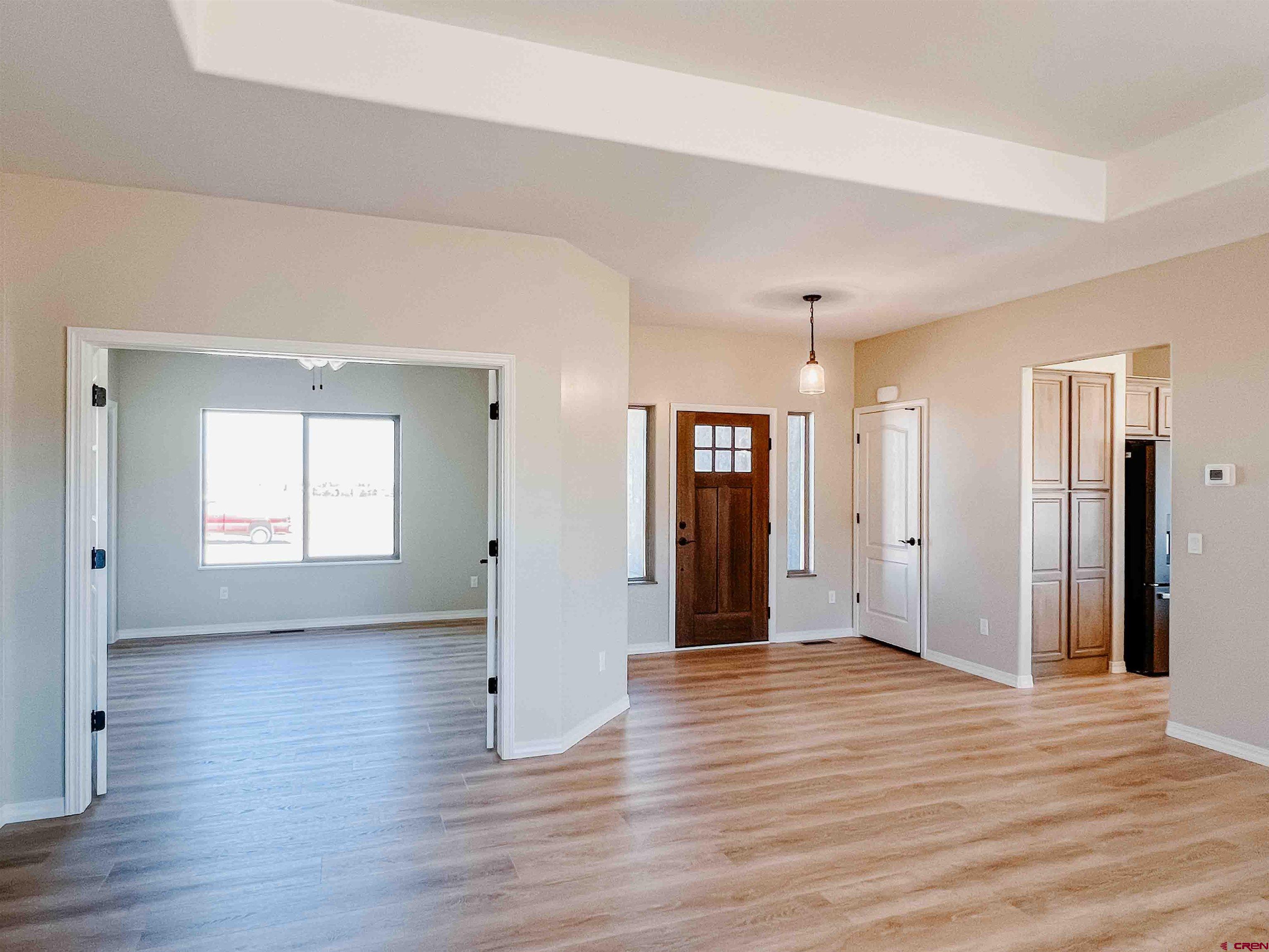 68364 Vernal Road Montrose, CO 81403 - Photo 7 of 11 a view of an empty room with wooden floor and a window
