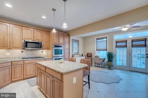 a kitchen with granite countertop a sink counter top space appliances and cabinets