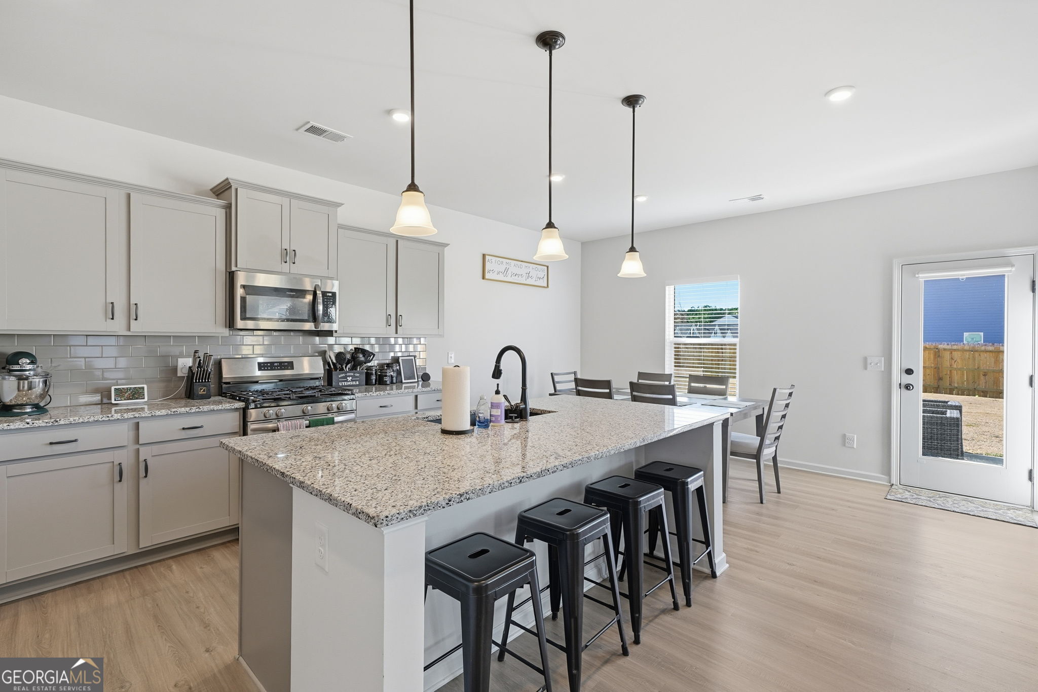 199 Graham Circle Adairsville, GA 30103 - Photo 11 of 49 a kitchen with stainless steel appliances granite countertop a kitchen island a stove a table and chairs in it
